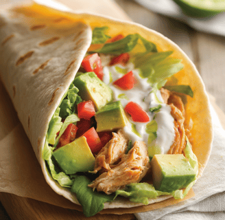 Low-carb chicken avocado wrap with shredded chicken, diced avocado, fresh lettuce, chopped tomatoes