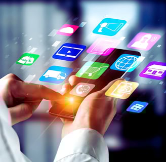 A leader in a white shirt uses a smartphone's touchscreen, with holographic apps emerging from the device, face unseen.