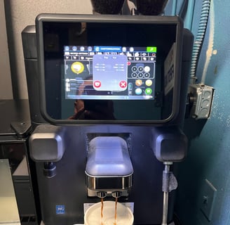 La Cimbali super-automatic espresso machine preparing cappuccino with touchscreen interface