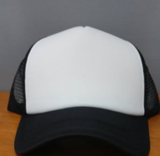 a black trucker hat with white front panel that's used for creating custom hat designs