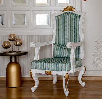 A carving chair and a table with a vase