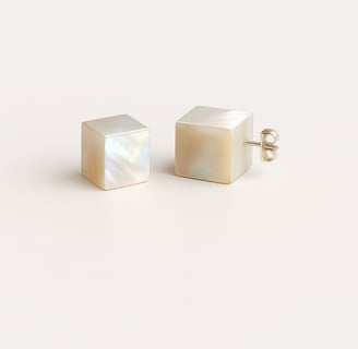 a pair of white pearl stud earring