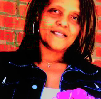 laurice a woman with a pink flower in her hand