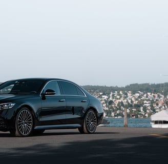 a black mercedes s class on lake zurich