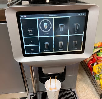 Egro touchscreen espresso machine preparing cappuccino in a self-service station