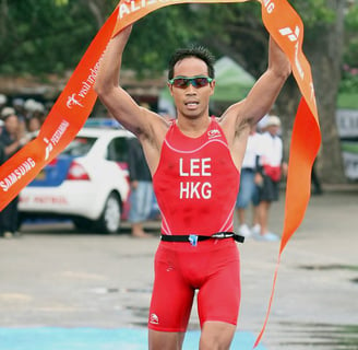 Photo of Daniel Lee, Hong Kong triathlete, crossing the finish line at the Bali 2008 triathlon