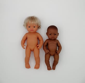 a 38cm Miniland doll next to a 32cm Miniland doll
