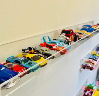 a collection of toy cars on display in a room