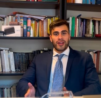 a man in a suit and tie sitting at a desk