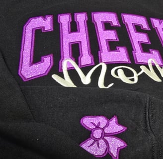Custom glitter appliqué embroidery purple & white thread on navy fabric – cheer spirit San Antonio