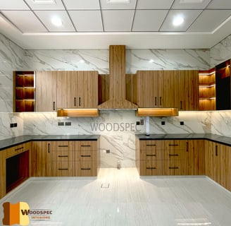 a kitchen with a marbled counter top and wooden cabinets