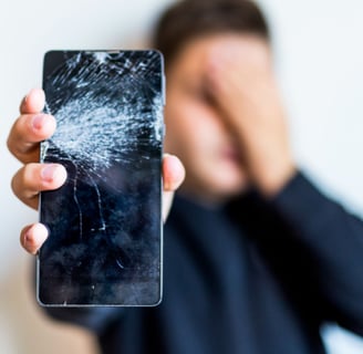a man holding a phone in front of a broken phone