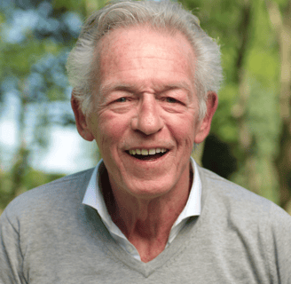 an older man with a smile on his face