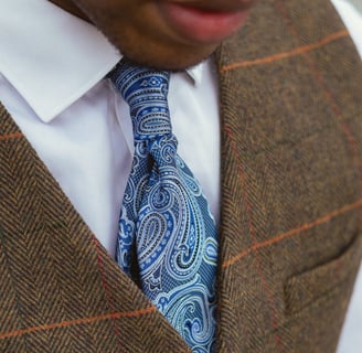 "Personal stylist sitting showing men tie"
