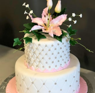 Elegant celebration cake decorated with refined details, available in chocolate or vanilla perfect for birthdays, weddings