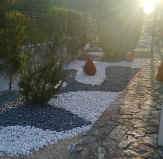 a garden with a gravel path and gravel path