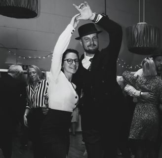 a man and woman dancing at a dance floor