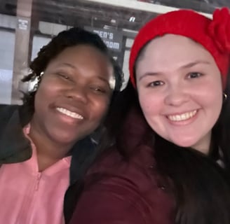 two women standing next to each other and smiling