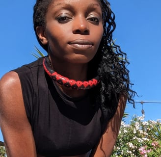 carmel zoum dancehall reggae reggaeton a woman with a red necklace and a black top