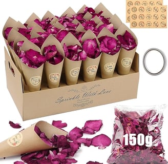 a box of pink rose petals on a table
