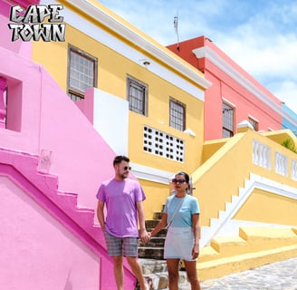 a man and woman holding hands and walking down a cobblestone street