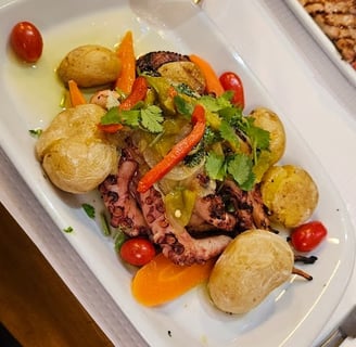 a plate of food and a glass of beer on a table