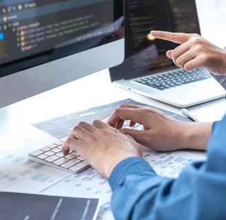Two people developing custom software solutions for business automation and increased efficiency
