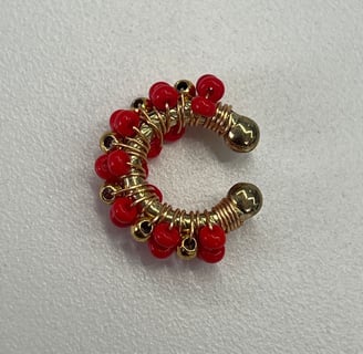 a red beaded bracelet with gold and red beads