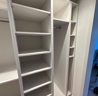 a closet with a closet door open and a closet door open
