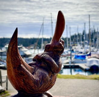 a wooden sculpture of an otter on a wooden moon