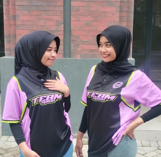 two women in hijab clothing standing next to each other
