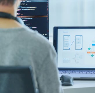 person working on sequence model with a laptop and computer monitor