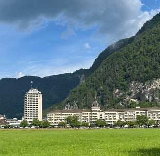 Looking across the Höhematte at Hotel Metropole and Victoria-Jungfrau in Interlaken Switzerland