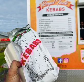 a person holding a bag of kebab