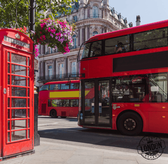 a red double decker busses parked next to a red phone booth in London