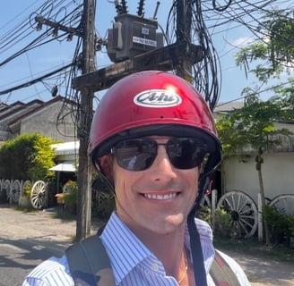 Travel writer Rick Silvia rides a scooter in Thailand
