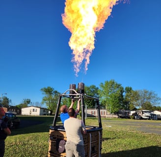 a man is standing in front of a hot air balloon
