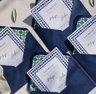 opened wedding invitations with custom envelope liner and leaves all around