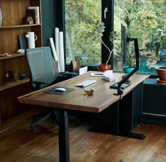 a desk with a laptop and a laptop on a wooden desk