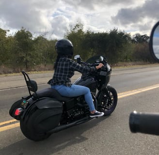 woman riding black motorcycle