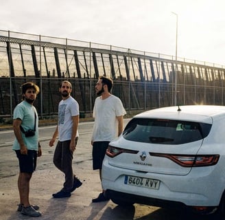 a film crew standing around a car on location