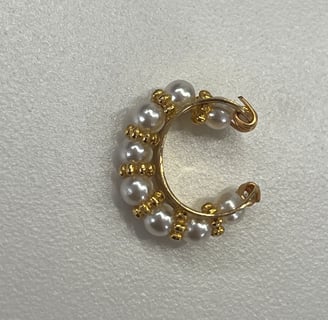 a pearled hoop earring with pearls and gold