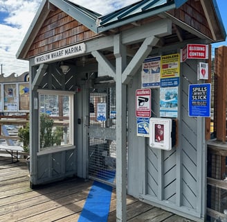 A gate with a sign that says Winslow wharf Marina