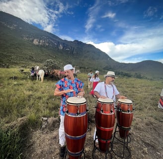 two men playing drums in a field