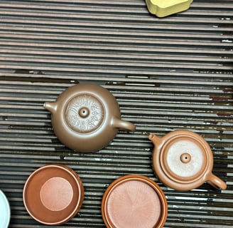 2 teapots placed on a teapot tray
