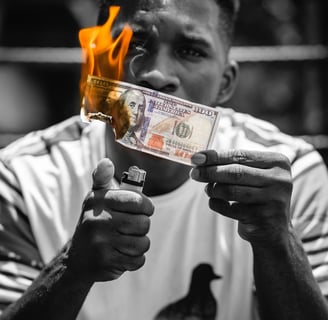 man setting 100 dollars on fire