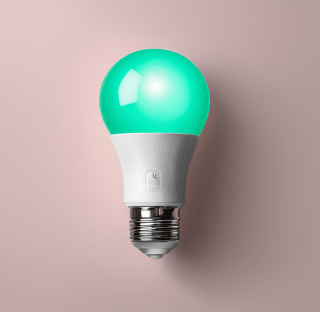 a green light bulb on a light bulb on a pink background