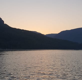 a boat is sailing on the water at sunset