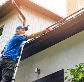 a man is cleaning a gutter gutter gutter gutter gutter gut