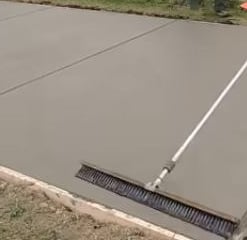 a sidewalk of concrete that is being leveled and formed